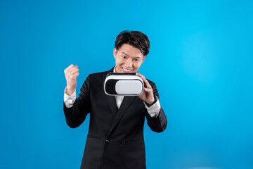 Smiling Asian businessman looking through VR connecting financial business report futuristic...
