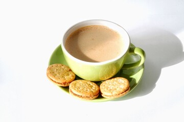 a cup of cappuccino and biscuit