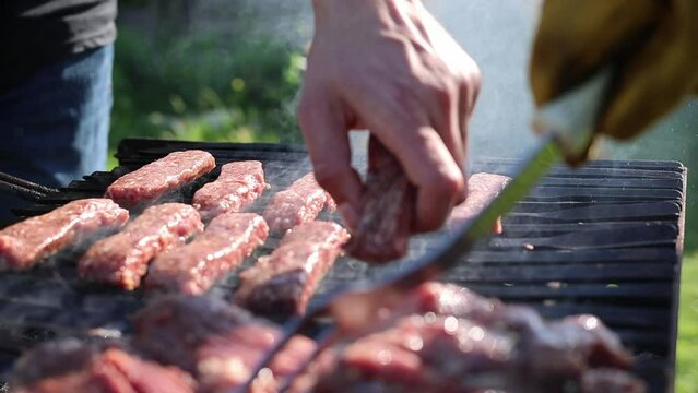 Grilling Outdoor Of Cevapi Serbian Sausages. Close-up Shot