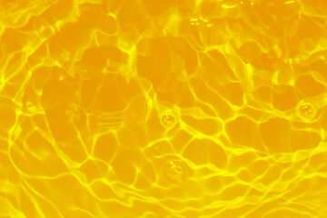 Orange water with ripples on the surface. Defocus blurred transparent blue colored clear calm water...