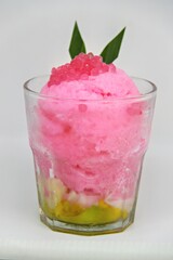 Es doger made from sugared sweet coconut milk based ice in pink syrup, served with red tapioca pearls, avocado, cassava tapai, black glutinous rice, jackfruit, diced bread and condensed milk.
