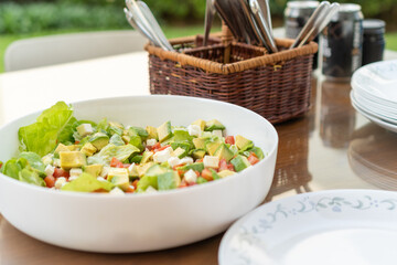 Bowl of salad ready to eat on a garden table