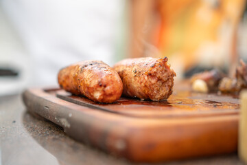 Freshly cooked pork sausages on a cutting board
