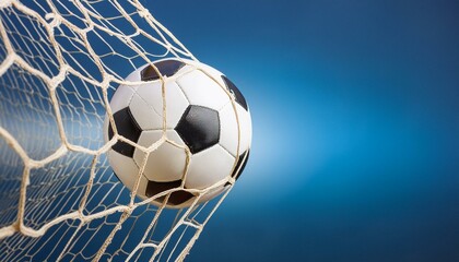 Naklejka premium Scored: Soccer Ball Finds the Net Against Blue Sky