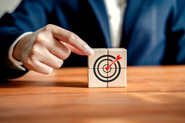 Businesswoman holding block wooden with icon dartboard target,.focus to goal Organizational, vision...