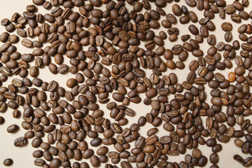 Top View Of Roasted Coffee Beans Over Beige Background