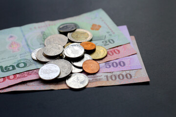 Banknotes with coins of the Thai baht