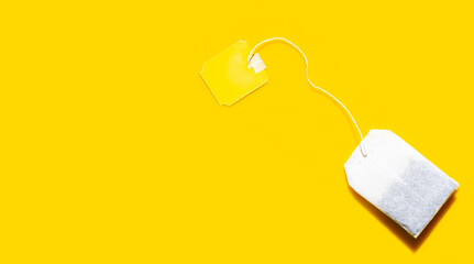 Tea bag on yellow background.