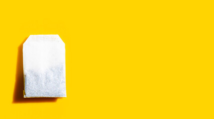 Tea bag on yellow background.