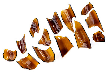 Broken brown bottle on white background