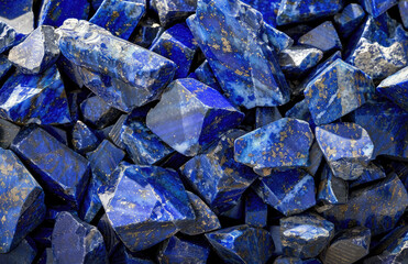 A close-up photo of blue lapis lazuli gemstones in their rough form. Created with Ai