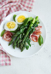 Fresh Asparagus and Prosciutto Salad Served With Boiled Eggs and Microgreens