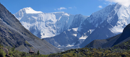 Mountain landscape, the foot of Belukha, Altai. White waters of the glacial river, snow-capped...