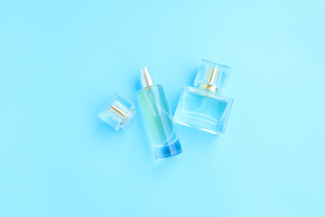 Perfume bottle on blue background, Glass bottle of perfumery