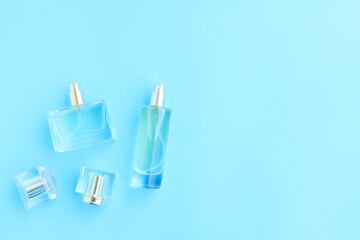 Perfume bottle on blue background, Glass bottle of perfumery