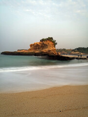 Beautiful beach with majestic boulders captured in slow speed shutter.