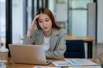 Asian businesswoman is tired and stressed in the office. Business concept.