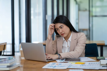 Asian businesswoman is tired and stressed in the office. Business concept.