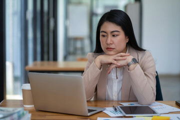 Asian businesswoman is tired and stressed in the office. Business concept.