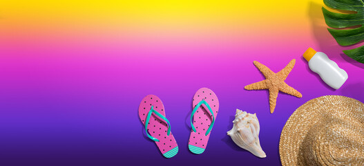Summer concept with a straw hat, sunblock, starfish, beach sandals and shell overhead view