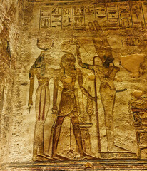 Wall relief depicting Ramesses II offering homage to Mut, Goddess of Creation and Min, God of Fertility at the rock cut Great Temple of  Abu Simbel built by Ramesses II in Nubia,Egypt