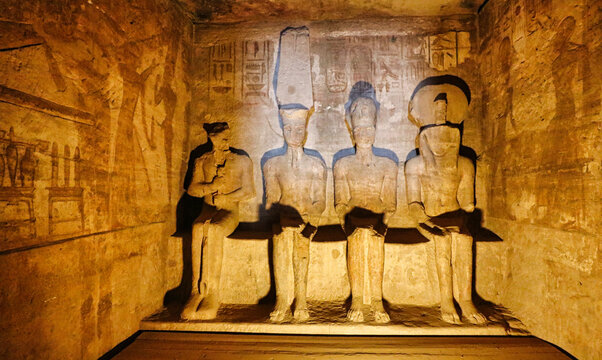 Statues of Ptah,Amun Re,Ramesses II and Re Horakhty inside the sanctum,sun directly shining on Amun and Ramesses during the Equinoxes at the Great Temple of  Abu Simbel built by Ramesses II in Egypt