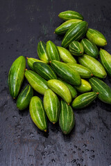 Few fresh organic Pointed gourd on a black background with selective focus.