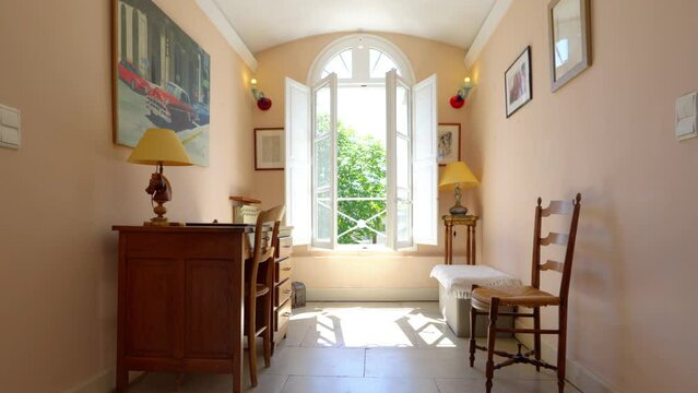 Slow rising shot revealing a open window at the top of the stairs in a villa