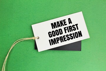 paper tag with the words Make A Good First Impression. Be positive. Be courteous and attentive.