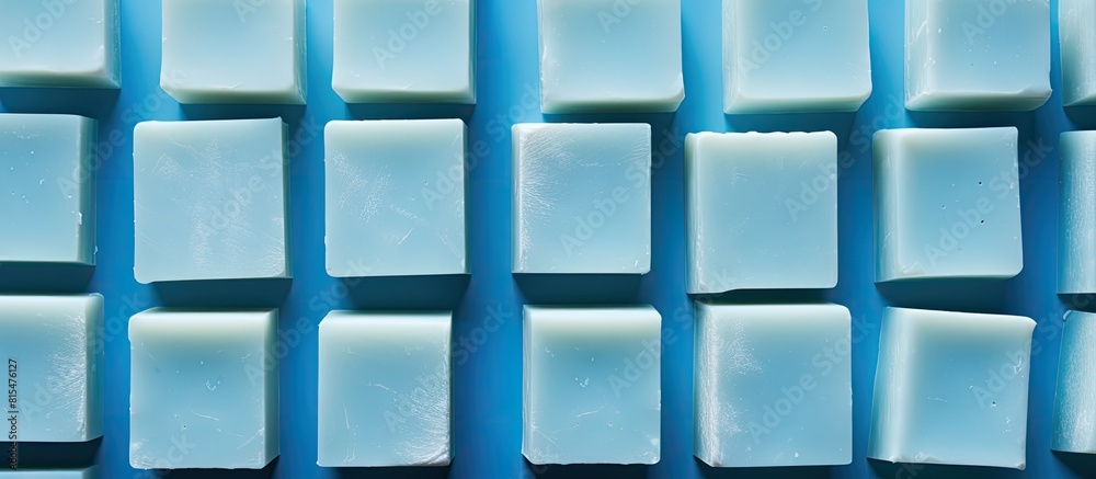 Aufkleber A top down view of soap bars arranged neatly on a blue background with plenty of copy space in the frame