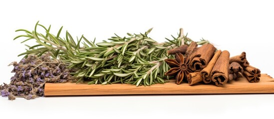 A copy space image of rosemary thyme and cinnamon on an old wooden table creates a herb and spice background set against a white backdrop