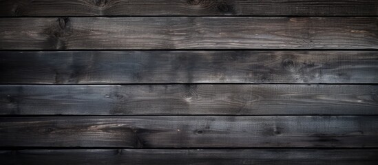 Fototapeta premium A vintage copy space image showcasing the work and design potential of a dark and textured old wooden background