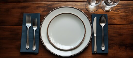 A photo of a dinner table with empty plates and cutlery providing ample space for additional elements or text