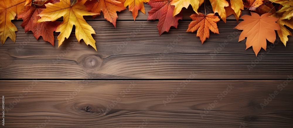 Aufkleber Top view of a wooden background with a composition of autumn leaves and ample space for text creating a copy space image