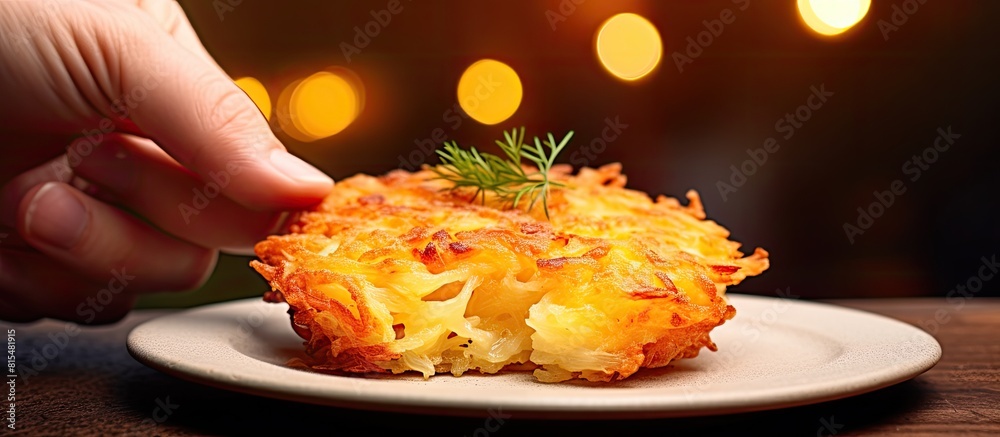 Poster in my hand i hold an american style breakfast hash brown against a blurred background with ample cop