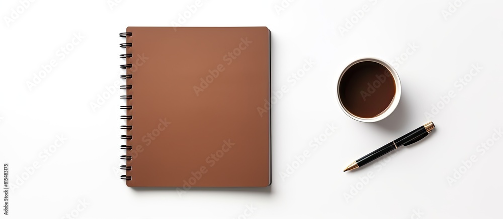 Fototapete A mockup of a high quality brown notebook and pen collection is presented from a top view in this design concept The image is isolated on a white background providing ample copy space