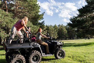 Friends Enjoying an Exciting ATV Ride in the Forest