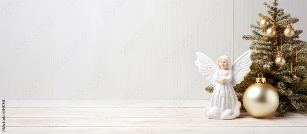 Poster on a white wooden surface there is a christmas tree toy featuring an angel and a deer it is beautifu