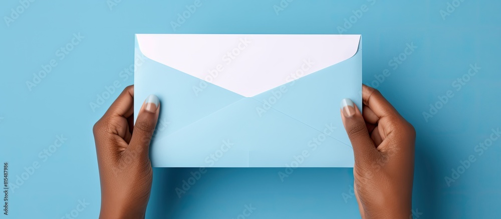 Leinwandbilder A blank card being inserted into an opened blue envelope by a hand with space for writing. Creative banner. Copyspace image