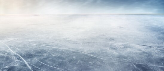 The ice surface of the skating rink is marked with numerous skating marks scratches and shadows created by the rink designs A copy space image of the rink shows these details