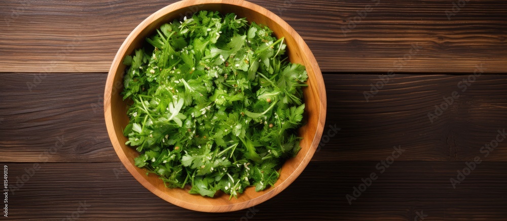 Poster a top down view of a wooden background featuring a bowl of fresh rucola salad with available copy sp