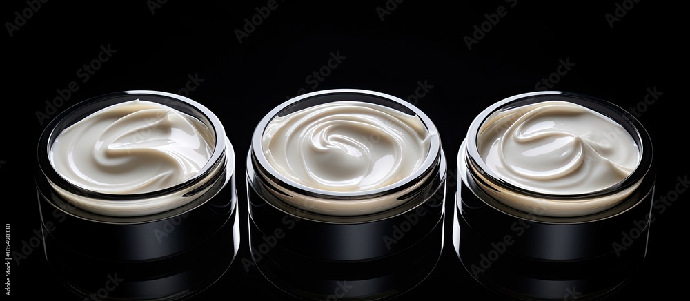 Poster A top view of three isolated face cream jars on a black background with copy space for an image