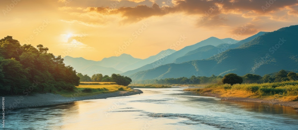 Poster during the golden hour of sunset a picturesque mountain river flows providing a serene backdrop with