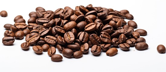 Obraz premium A high quality macro image of roasted brown and black coffee beans is isolated on a white background providing ample copy space for text