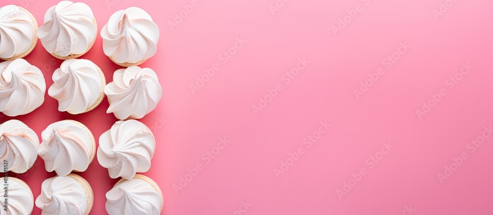 Aufkleber a flat lay style image featuring homemade mini meringues in vibrant colors set against a pink backgr