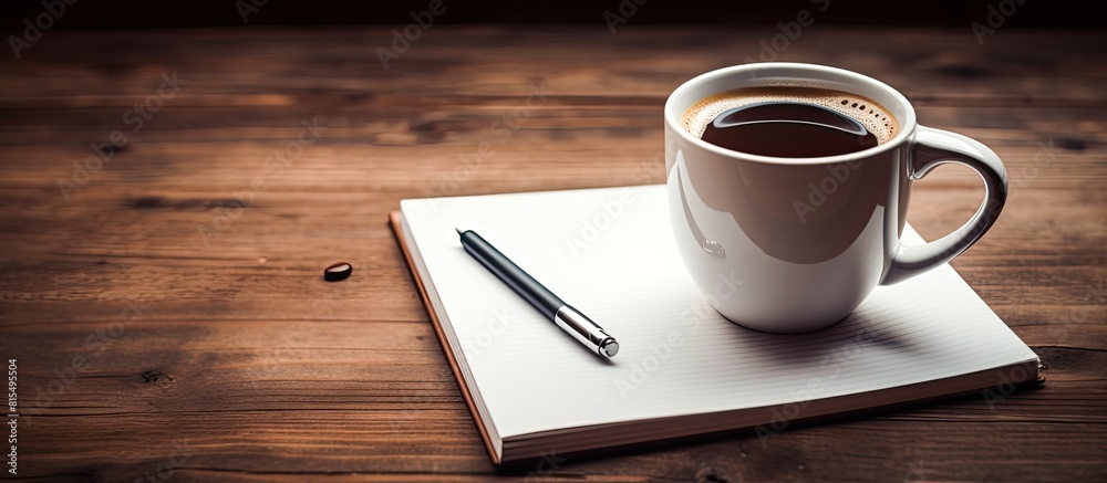 Leinwandbilder a copy space image featuring a close up view of a coffee cup pen and notebook placed on a wooden bac
