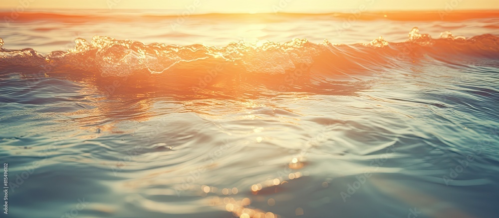Poster blurry tropical sunset beach with the bokeh effect of sunlight on the waves creates an abstract back