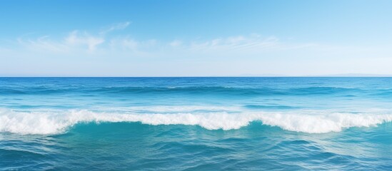 Obraz premium A serene expansive ocean with clear blue waves and a natural backdrop perfect for adding images or text. Creative banner. Copyspace image