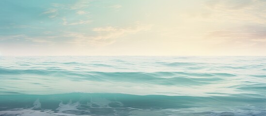 Naklejka premium A calming scene of the ocean s serene surface with the soft morning light creating a textured effect Copy space image