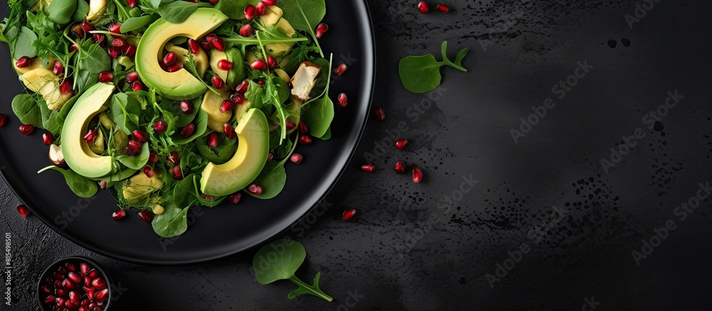 Poster top view of a visually appealing avocado salad featuring baby spinach and pomegranate presented on a